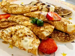 Crepes con crema agria, fresas y caramelo