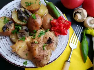 Pollo con champiñones y patatas al horno