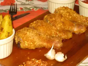 Jamoncitos de pollo rebozados con copos de maíz al horno