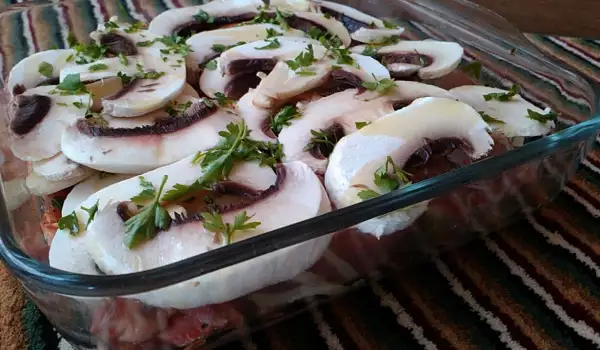 Filetes de cerdo con champiñones en una fuente de vidrio