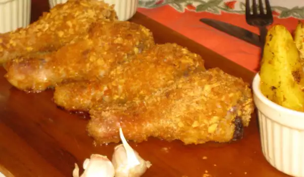 Jamoncitos de pollo rebozados con copos de maíz al horno